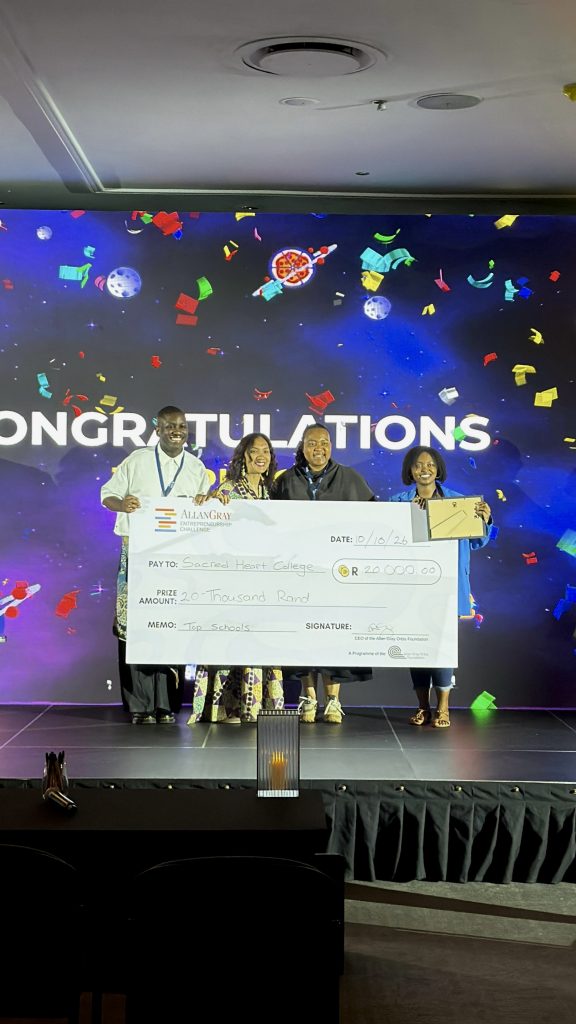 Sacred Heart College representatives on stage holding the R20 000 Top Schools prize cheque and certificate at the Allan Gray Entrepreneurship Challenge Summit